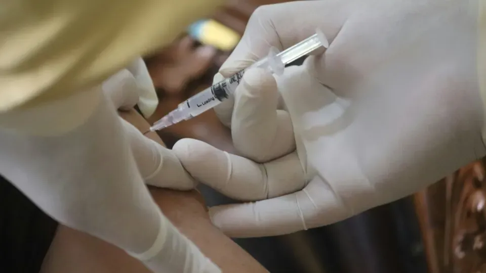 Hands in gloves giving injection 