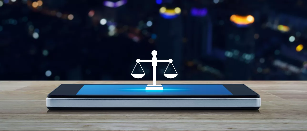 A phone with a graphic of scales on it on a table